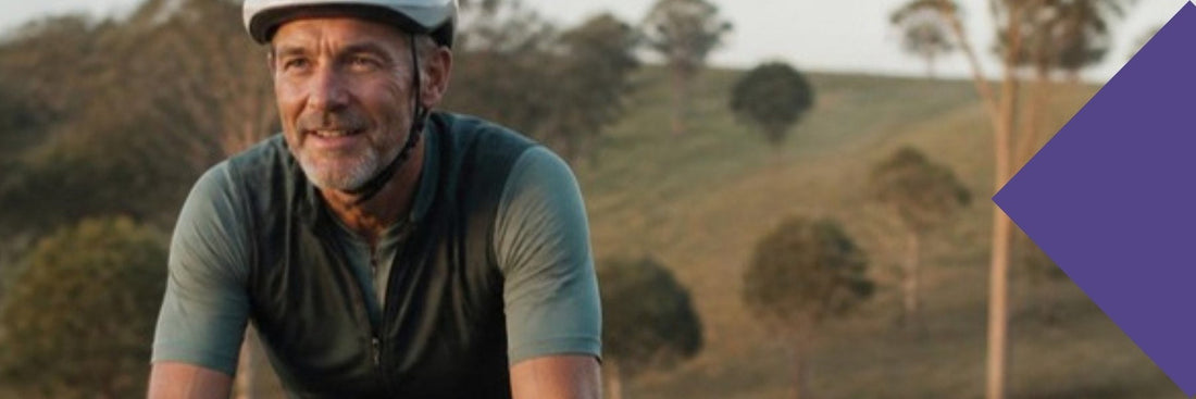 A masters cyclist riding a quiet country road in morning light