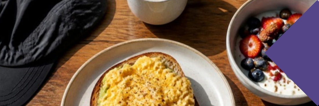 A breakfast of scrambled eggs on toast, Greek yoghurt with berries and a coffee